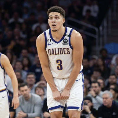 Basketball player with a visible hamstring strain, looking concerned, during a game. Arena background, professional sports photography, no text, no words, no typography, 8K, clean image.